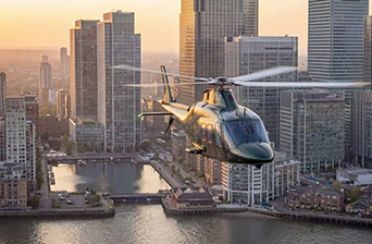 Helicopter flying with a city skyline in the background